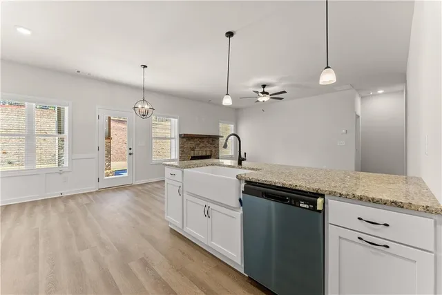 a kitchen with a sink chandelier and refrigerator