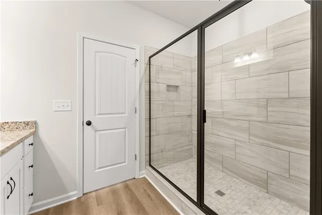 a bathroom with a glass shower door