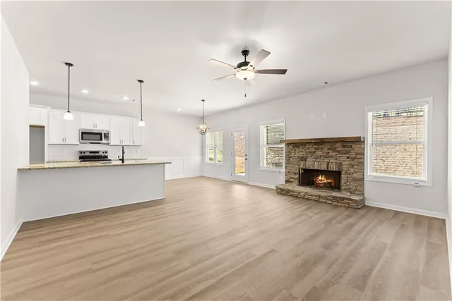 a view of kitchen with cabinets and fireplace