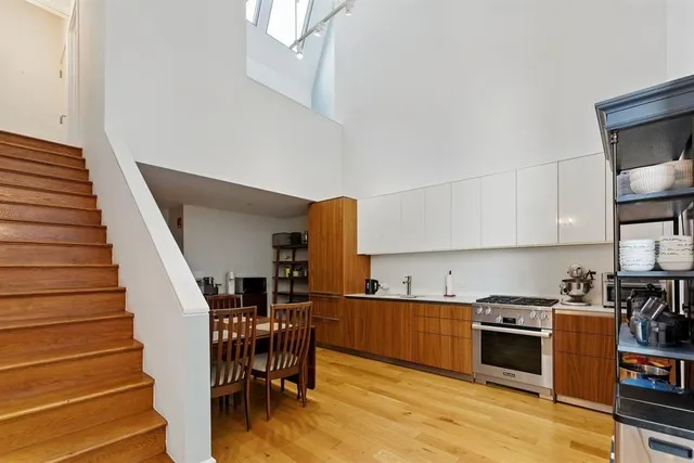 a kitchen with wooden floors and appliances