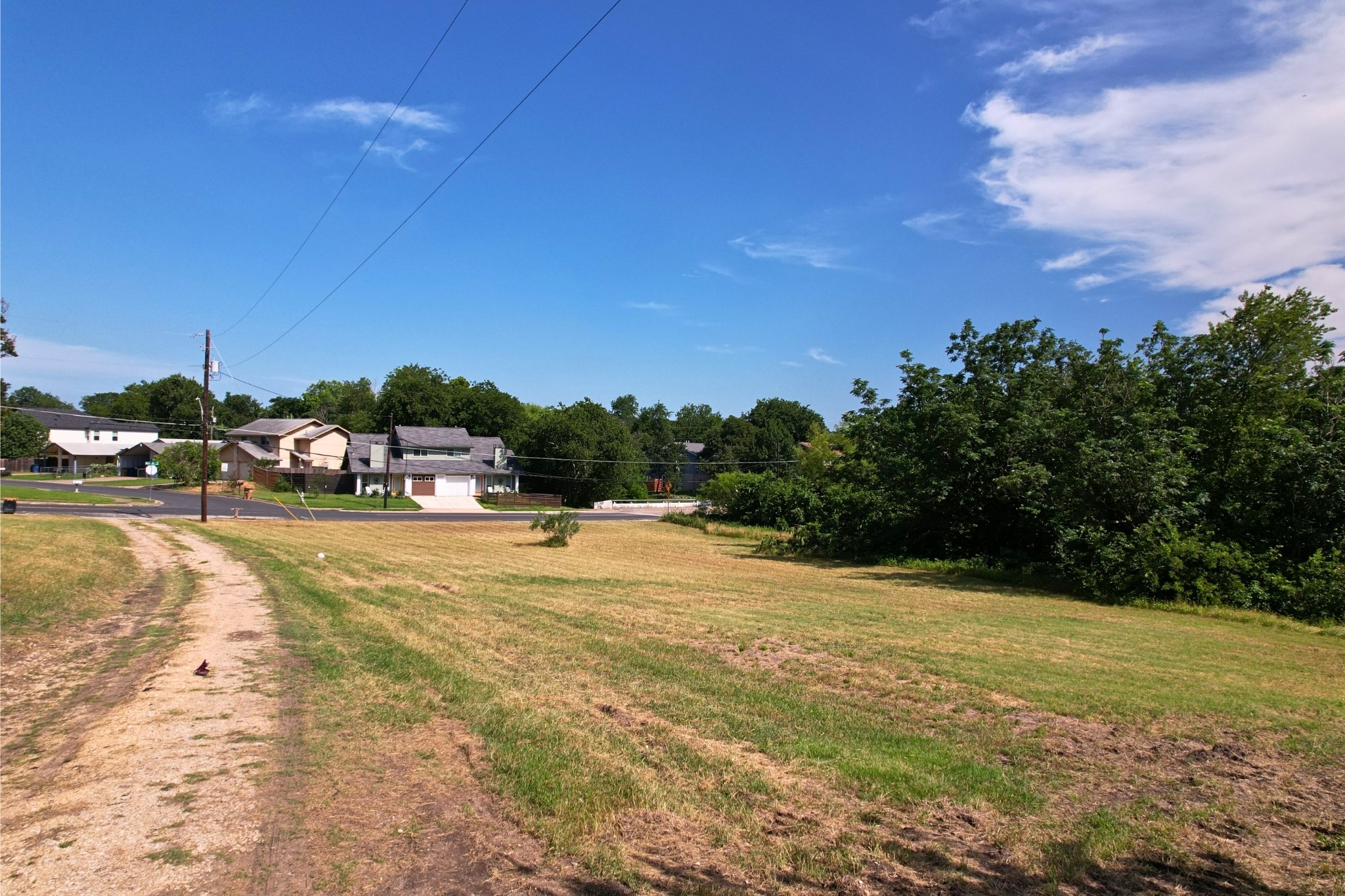 2610-2606 Metcalfe Road Austin, TX 78741 - Photo 5 of 20 A spacious, cleared lot ready for your dream home, nestled in a community with verdant surroundings.