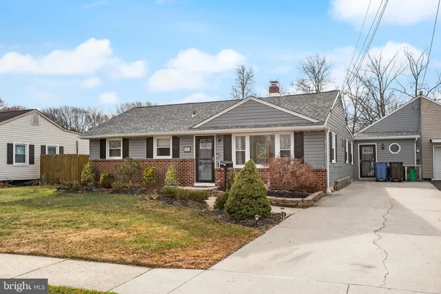 a front view of a house with a garden and plants
