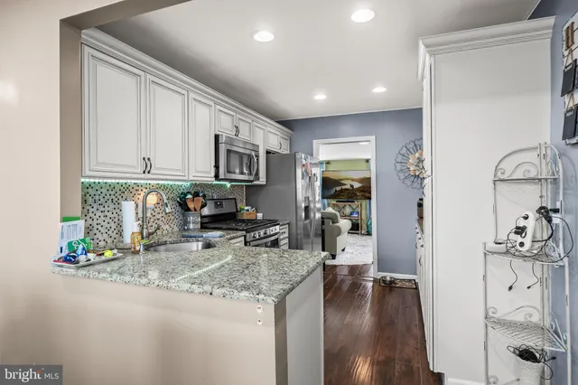 a kitchen with sink refrigerator and microwave