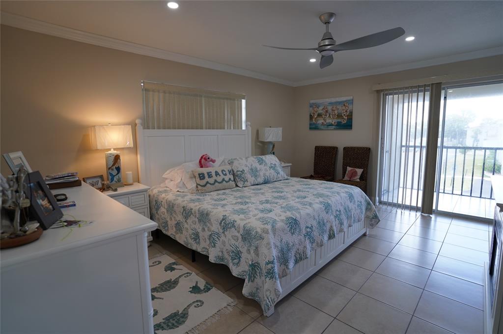 1531 Placida Road, Unit 204 Englewood, FL 34223 - Photo 12 of 52 a bed room with a bed and a chandelier