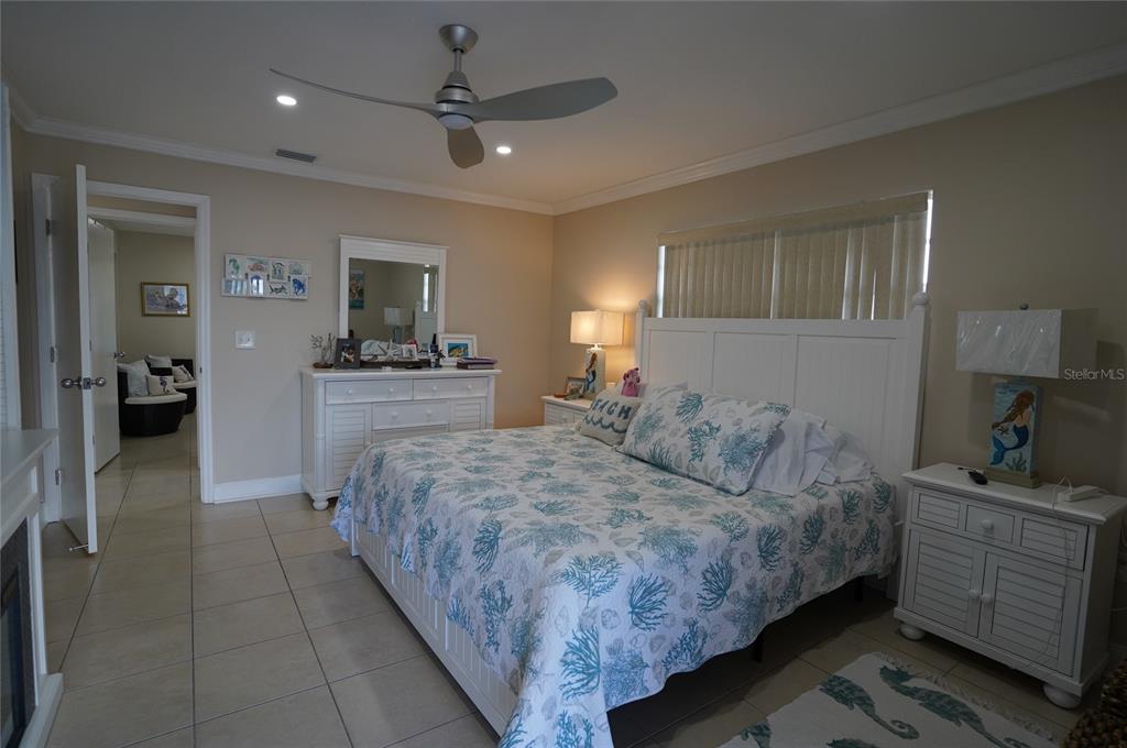 1531 Placida Road, Unit 204 Englewood, FL 34223 - Photo 13 of 52 a bedroom with a large bed and flat tv screen on dresser