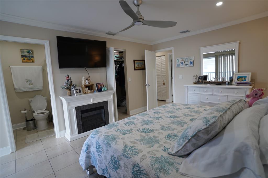 1531 Placida Road, Unit 204 Englewood, FL 34223 - Photo 15 of 52 a spacious bedroom with a bed and a flat screen tv