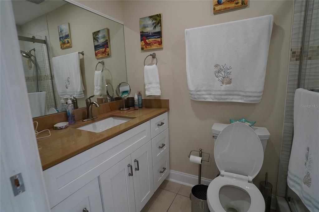 1531 Placida Road, Unit 204 Englewood, FL 34223 - Photo 16 of 52 a bathroom with a toilet sink and mirror
