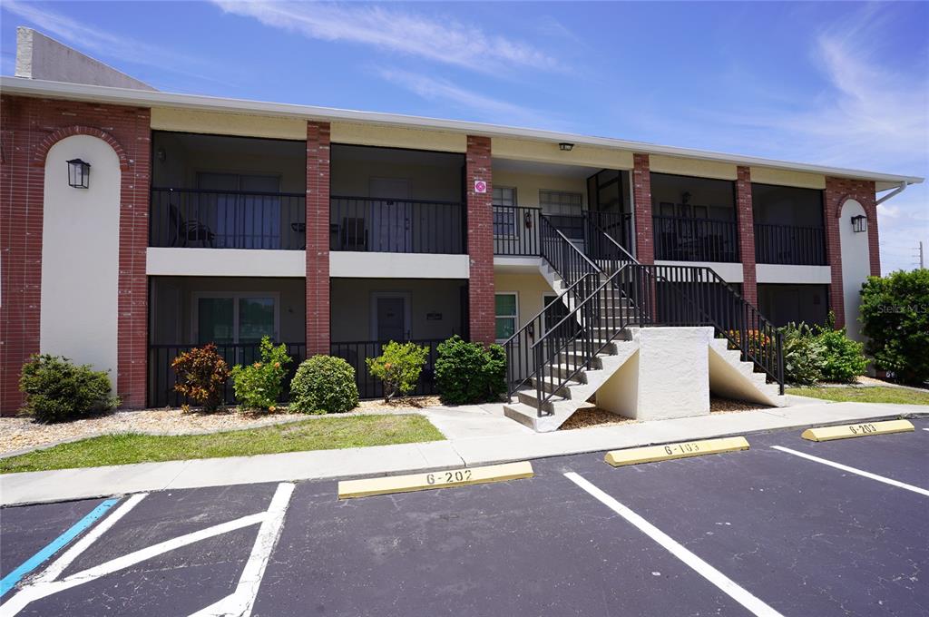1531 Placida Road, Unit 204 Englewood, FL 34223 - Photo 2 of 52 a front view of a house with a yard