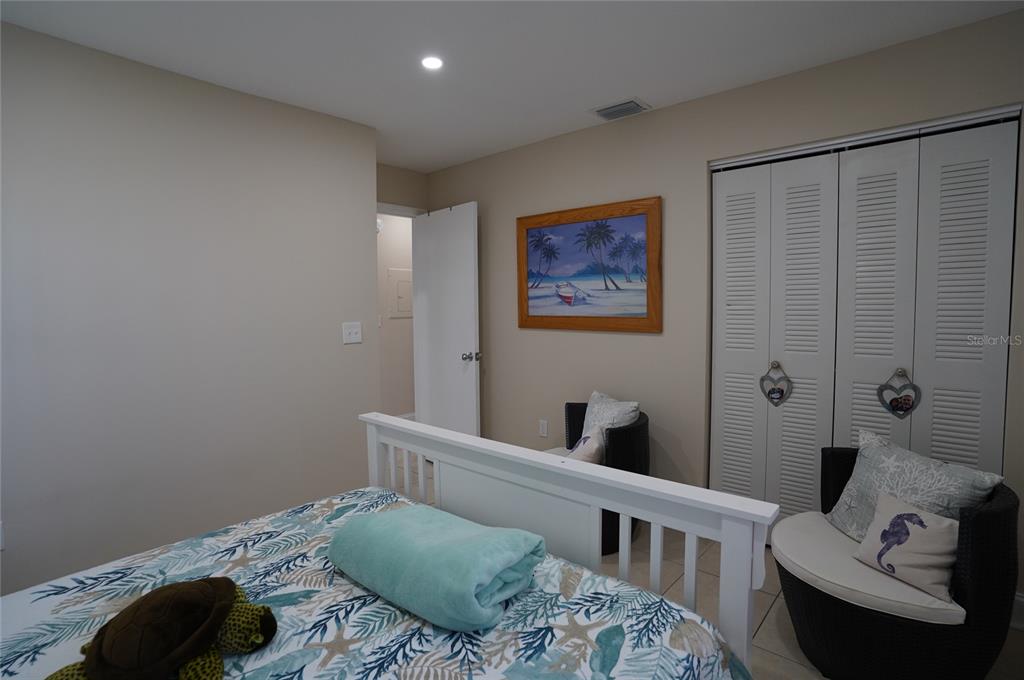 1531 Placida Road, Unit 204 Englewood, FL 34223 - Photo 22 of 52 a bedroom with a bed and furniture