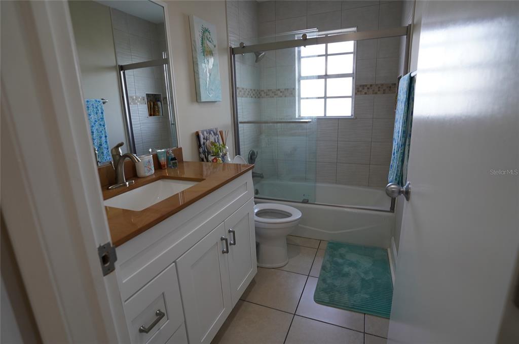 1531 Placida Road, Unit 204 Englewood, FL 34223 - Photo 23 of 52 a bathroom with a granite countertop sink toilet and shower