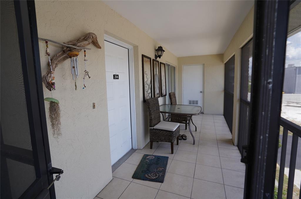1531 Placida Road, Unit 204 Englewood, FL 34223 - Photo 4 of 52 a view of a hallway with a dining area