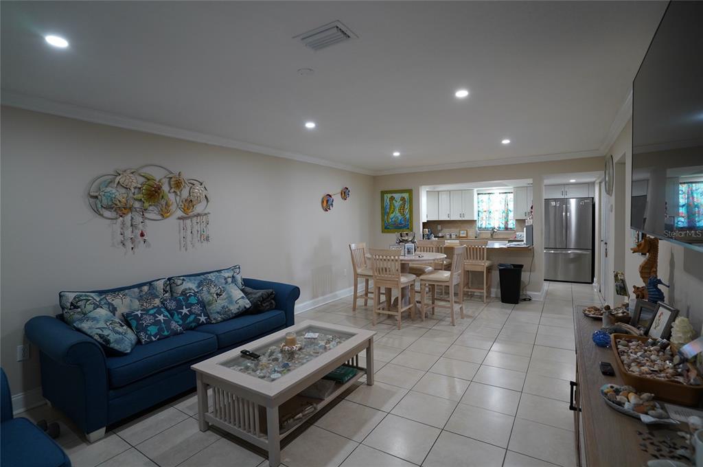 1531 Placida Road, Unit 204 Englewood, FL 34223 - Photo 5 of 52 a living room with furniture a rug and a flat screen tv