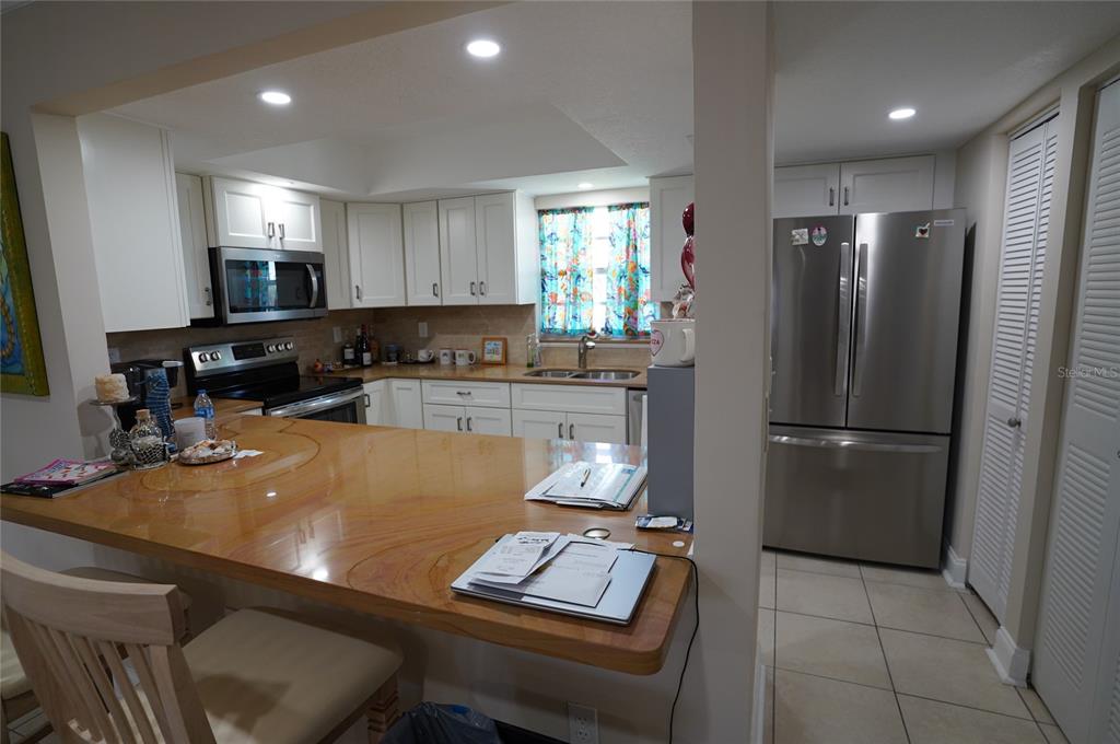 1531 Placida Road, Unit 204 Englewood, FL 34223 - Photo 9 of 52 a room with stainless steel appliances furniture and kitchen view