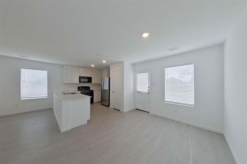 1601 Parlier Street McKinney, TX 75071 - Photo 13 of 29 a view of empty room with kitchen and window