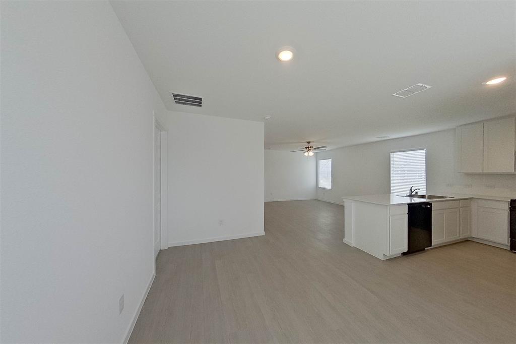 1601 Parlier Street McKinney, TX 75071 - Photo 14 of 29 a view of a kitchen with a sink and dishwasher stove top oven with wooden floor