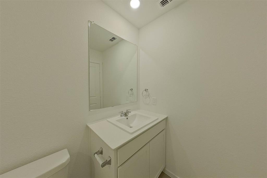 1601 Parlier Street McKinney, TX 75071 - Photo 18 of 29 a bathroom with a sink toilet and vanity
