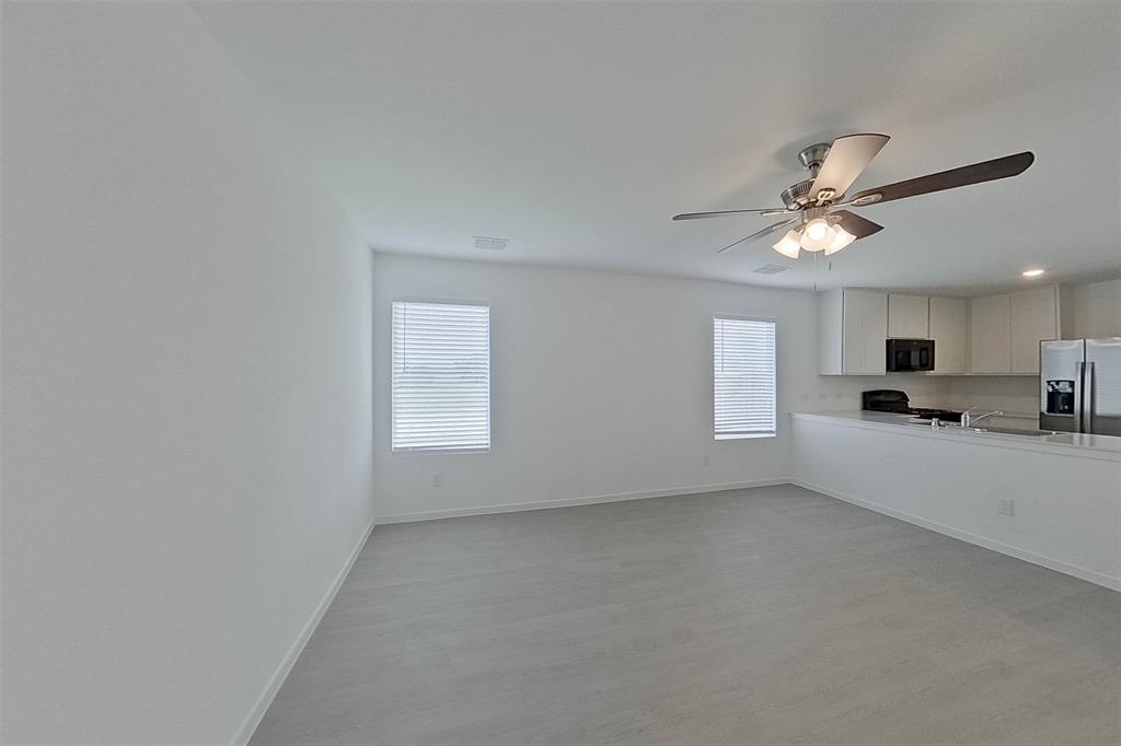 1601 Parlier Street McKinney, TX 75071 - Photo 8 of 29 a view of a livingroom with a ceiling fan and window
