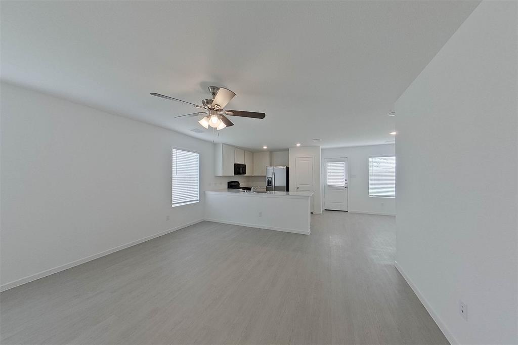 1601 Parlier Street McKinney, TX 75071 - Photo 9 of 29 a view of a livingroom with a chandelier fan and windows