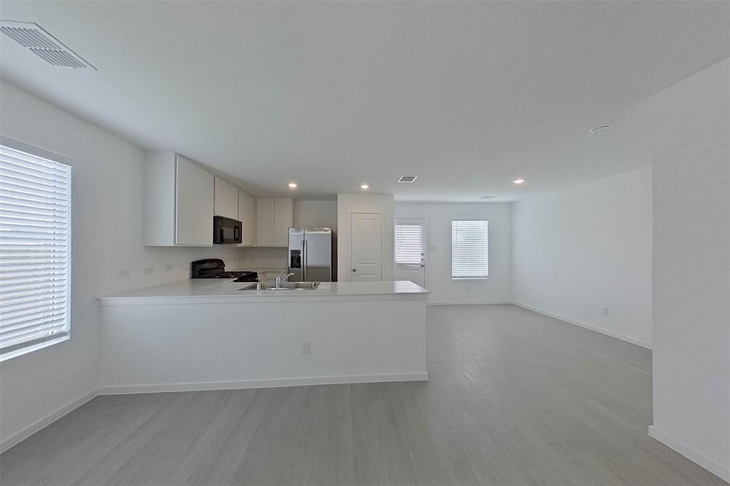 1601 Parlier Street McKinney, TX 75071 - Photo 10 of 29 a large white kitchen with a large window