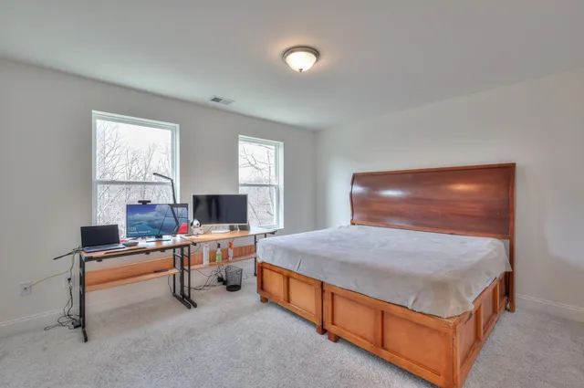 a bedroom with a bed and a table