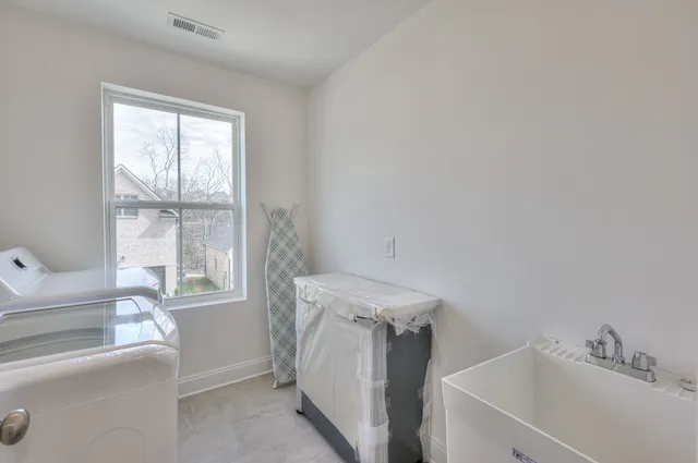 a utility room with a window dryer and washer