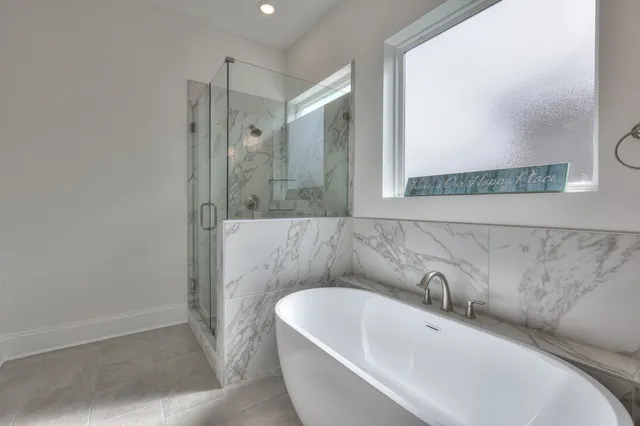 a bathroom with a bathtub and shower