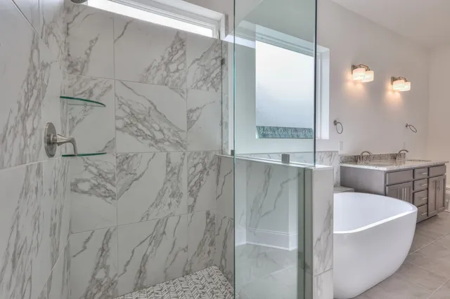 a bathroom with a bathtub and shower