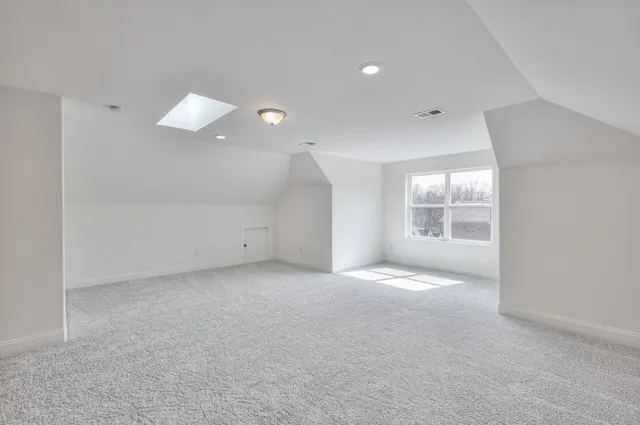 an empty room with windows and entrance