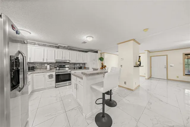 a kitchen with a white cabinets and window