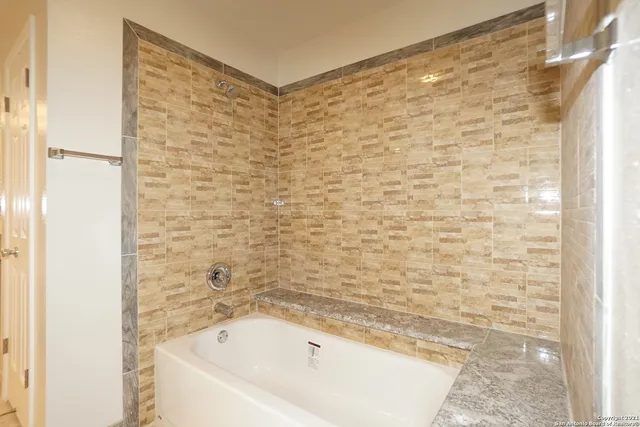 a bathroom with a bathtub and shower