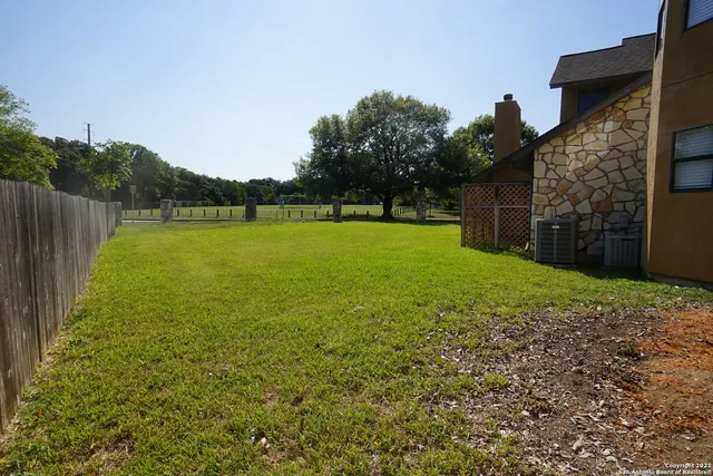 a view of outdoor space with swimming pool and green space
