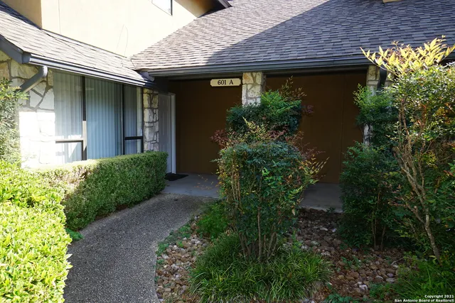 a front view of a house with plants