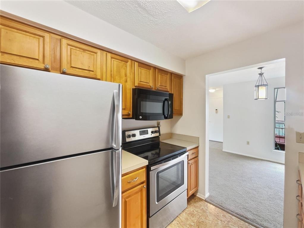 524 Orange Drive, Unit 22 Altamonte Springs, FL 32701 - Photo 6 of 18 a kitchen with a refrigerator a stove and a sink