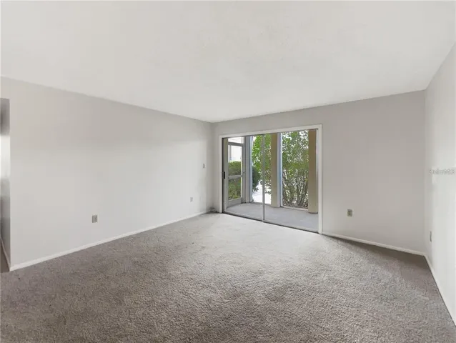 a view of an empty room with windows