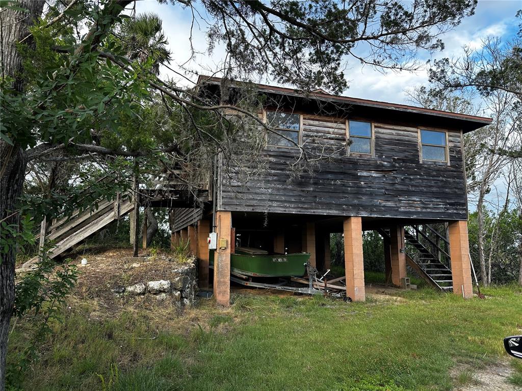 14271 West St Martins Road Crystal River, FL 34429 - Photo 1 of 1 a view of a house with a yard balcony and a tree