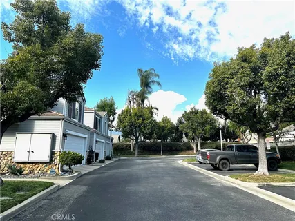 a view of a street with a car park in front of it
