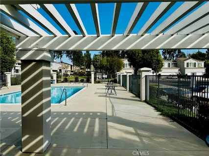 a view of a patio with table and chairs under an umbrella