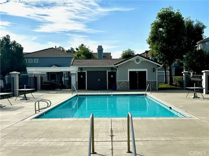 a view of a house with swimming pool and sitting area