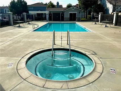 a swimming pool with outdoor seating and yard