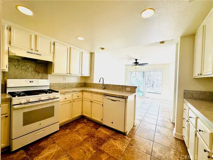 a kitchen with a stove top oven sink and cabinets