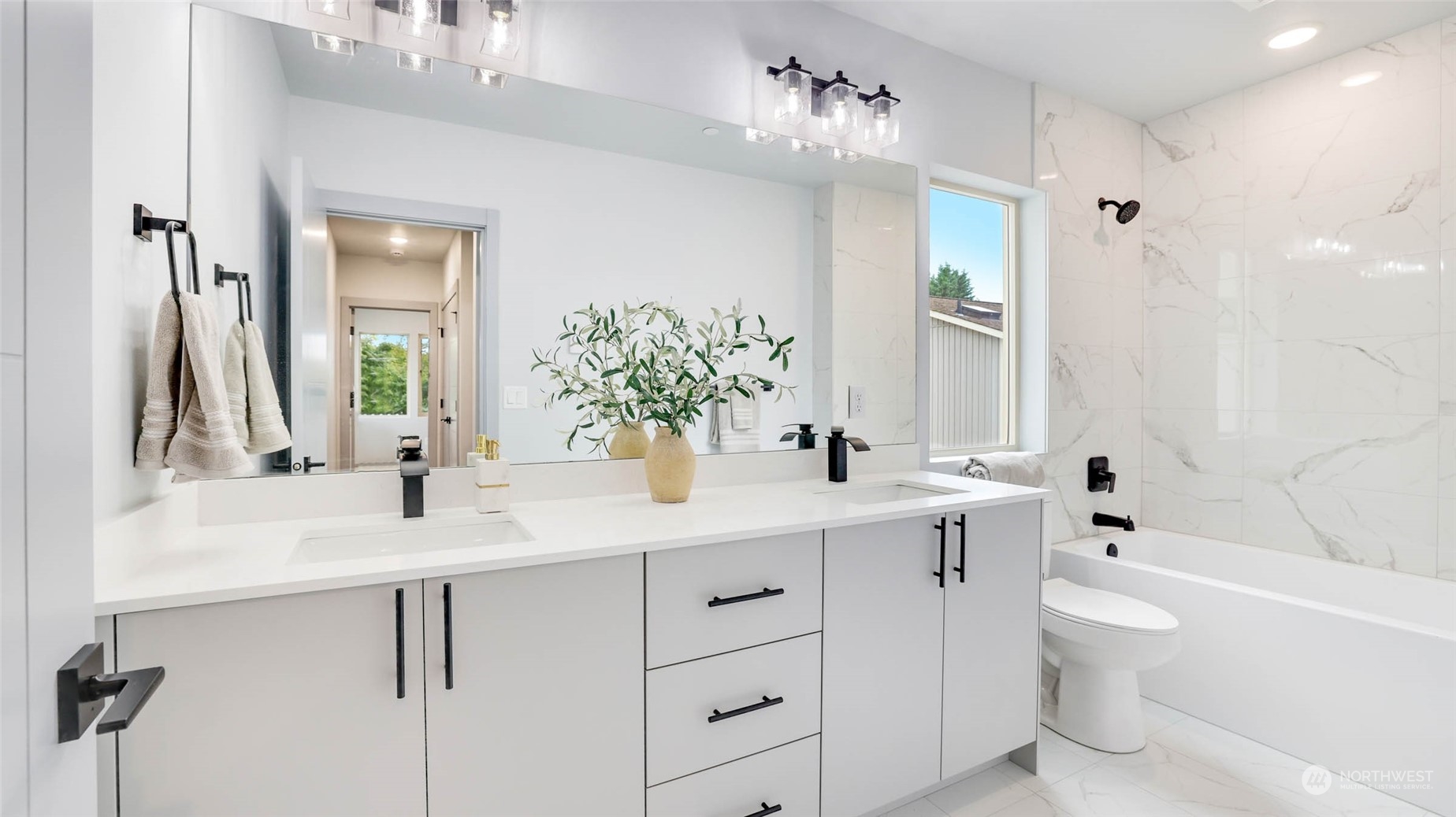 1713 14th Avenue South Seattle, WA 98144 - Photo 12 of 26 a bathroom with a sink a toilet and a large mirror