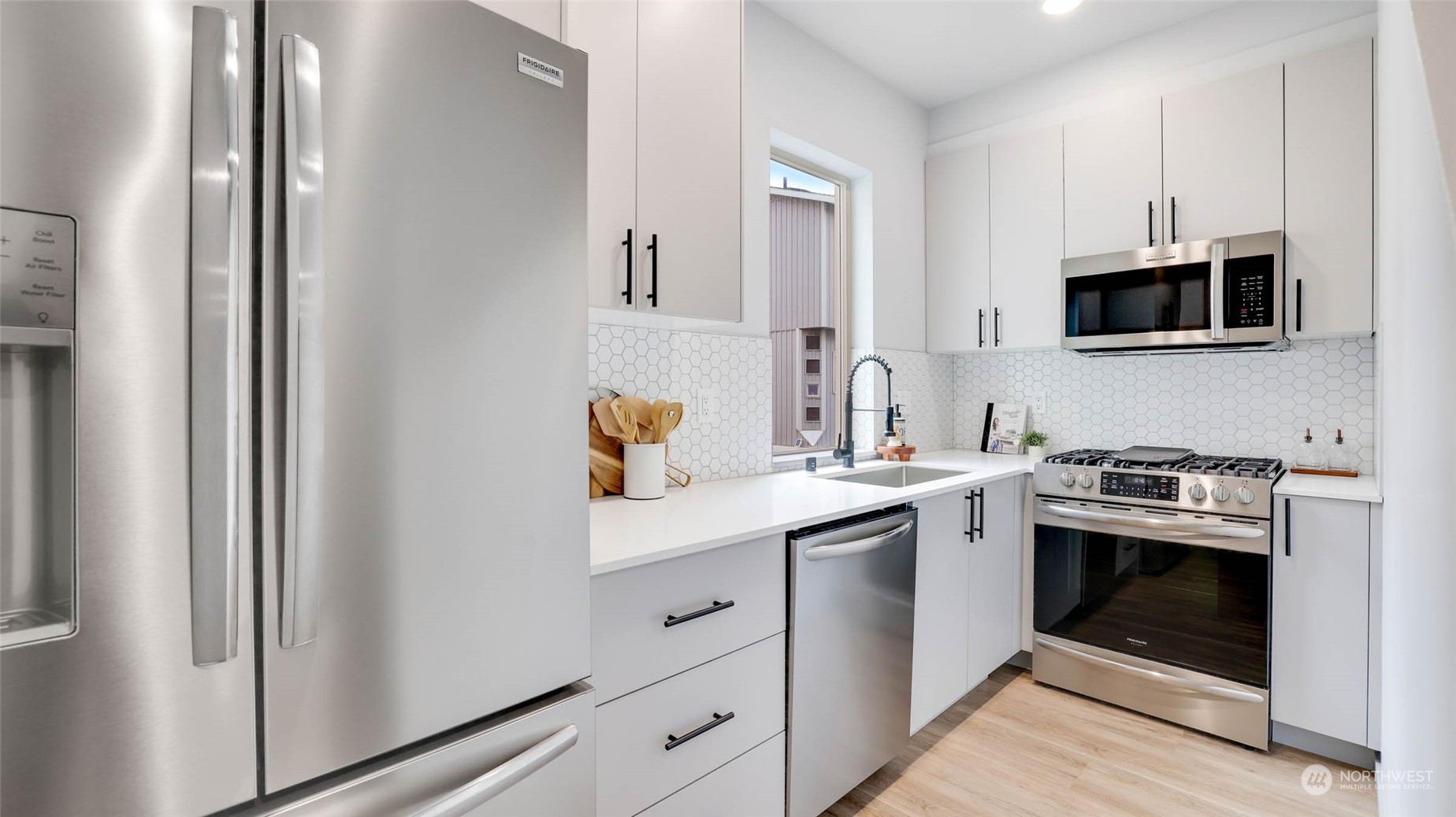 1713 14th Avenue South Seattle, WA 98144 - Photo 8 of 26 a kitchen with stainless steel appliances a sink stove and microwave
