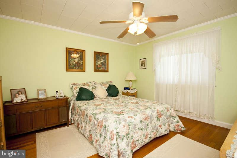 1932 Church Road Baltimore, MD 21222 - Photo 18 of 27 a bedroom with a bed and a chandelier