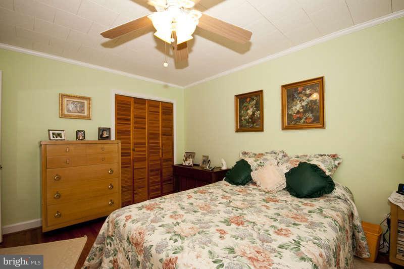 1932 Church Road Baltimore, MD 21222 - Photo 19 of 27 a bedroom with a bed and dresser with mirror