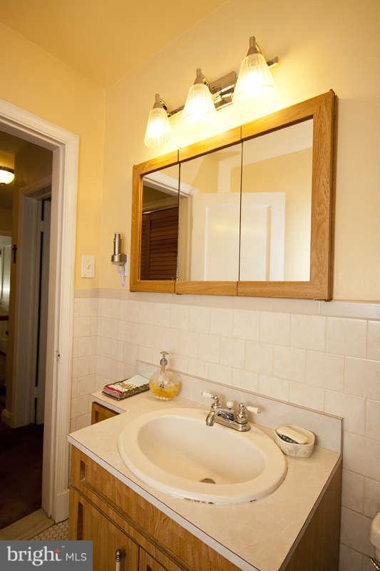 1932 Church Road Baltimore, MD 21222 - Photo 23 of 27 a bathroom with a sink and a mirror