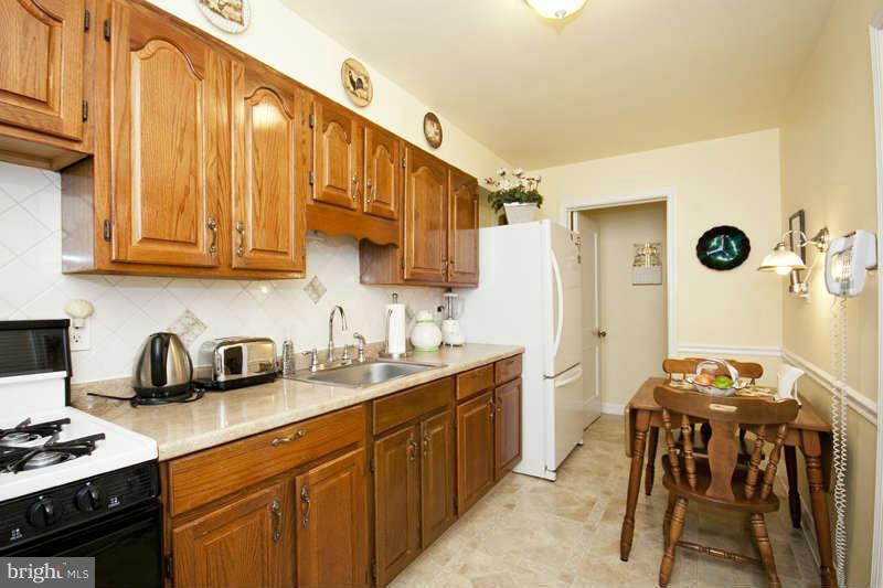 1932 Church Road Baltimore, MD 21222 - Photo 10 of 27 a kitchen with stainless steel appliances granite countertop a sink a stove and a refrigerator