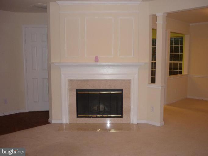 8214 Winstead Place, Unit 204 Manassas, VA 20109 - Photo 5 of 7 a living room with a fireplace