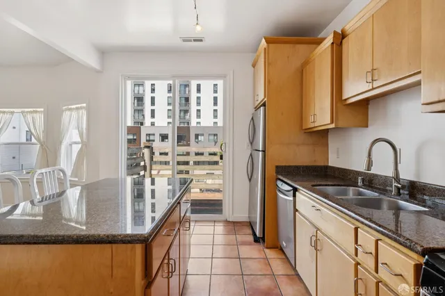 a kitchen with stainless steel appliances granite countertop a sink and cabinets