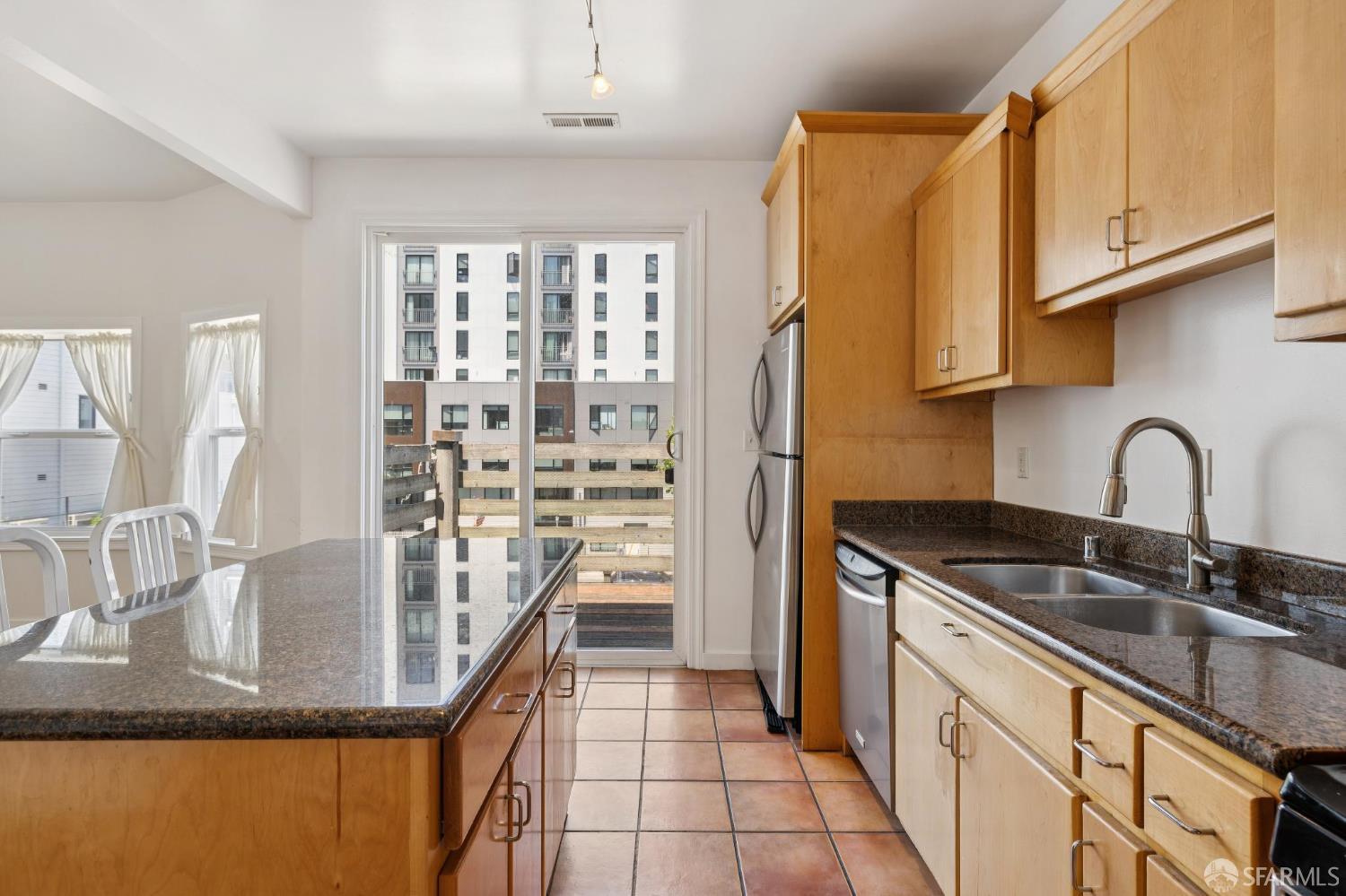 984 Harrison Street San Francisco, CA 94107 - Photo 11 of 34 a kitchen with stainless steel appliances granite countertop a sink and cabinets