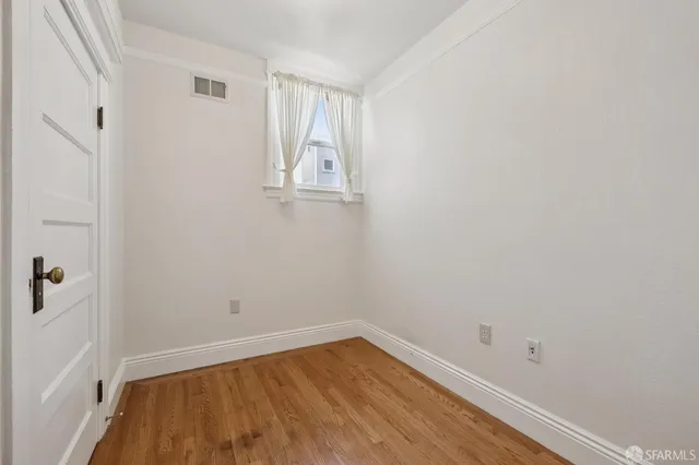 a view of room with window and hardwood floor